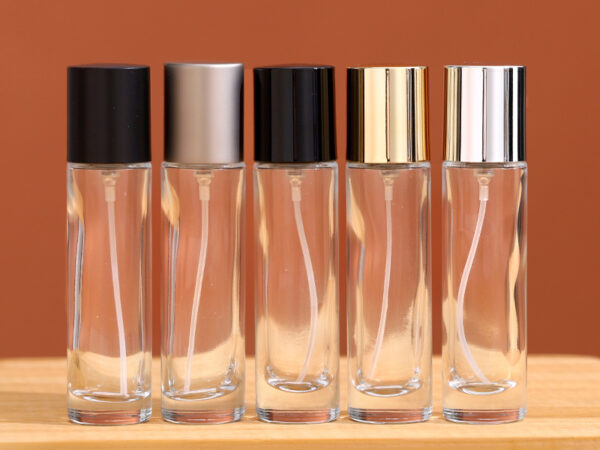 15ml slim clear cylindrical glass perfume bottle with matte black and gold caps, 25mm diameter
