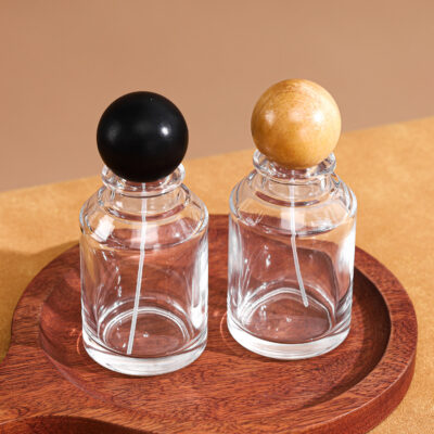 RX019-XB225 100ml clear cylindrical perfume bottle with dark brown light brown and black wood ball lids
