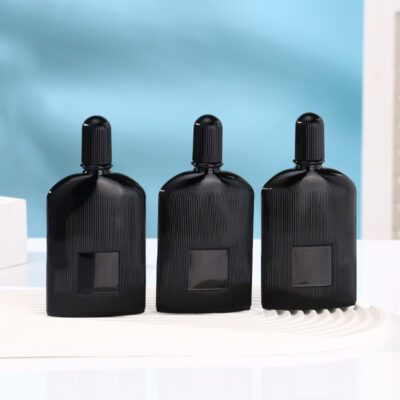Matte black ribbed glass perfume bottle with gold and black atomizers and matching fluted caps