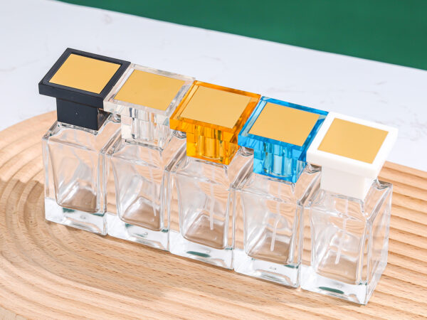 clear square glass perfume bottle with blue acrylic cap and silver sprayer