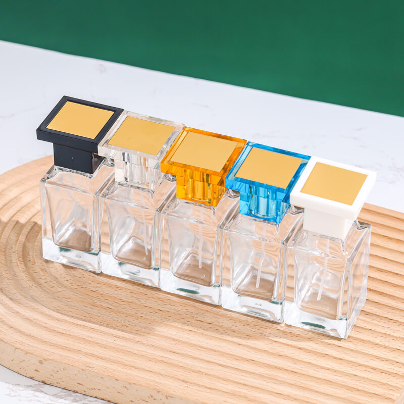 clear square glass perfume bottle with blue acrylic cap and silver sprayer