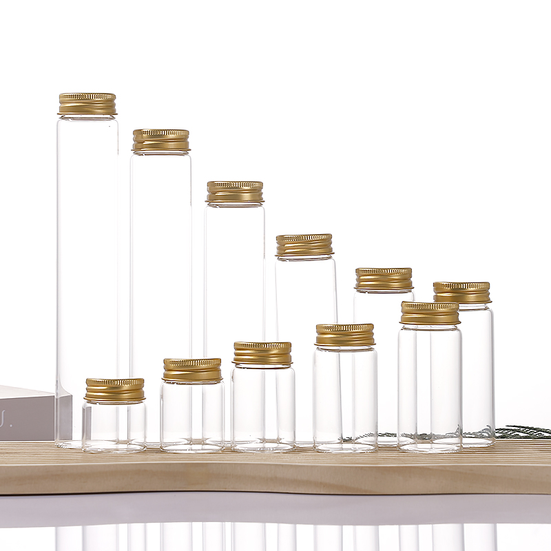 Clear glass vial with pre-painted golden aluminum screw cap