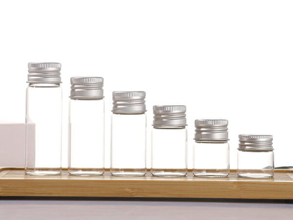 Clear borosilicate glass vials with silver aluminum screw caps, 5ml to 20ml+