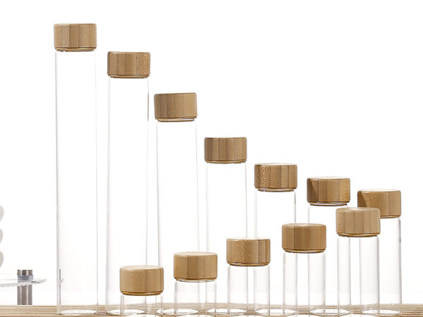 Borosilicate glass jars with screw-on wood caps in bamboo, acacia, and transfer-printed finishes, 12ml to 110ml
