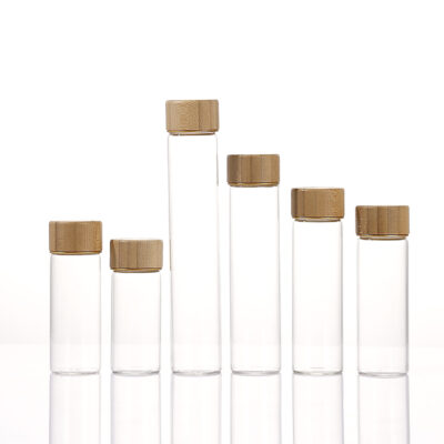 Borosilicate glass jars with screw-on wood caps in bamboo, acacia, and transfer-printed finishes, 12ml to 110ml