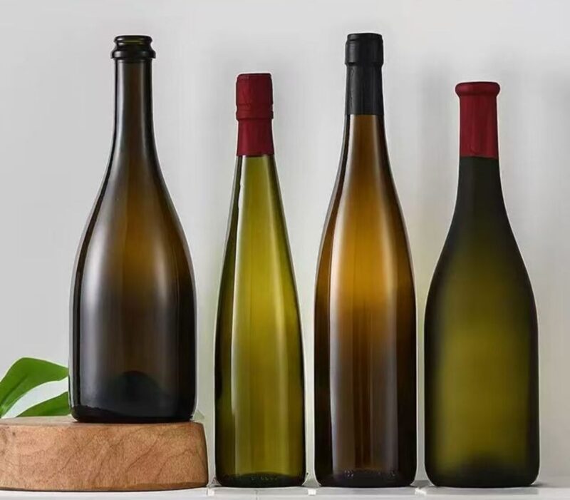 Premium glass wine and champagne bottles in antique green, amber, and clear, 187ml to 1500ml