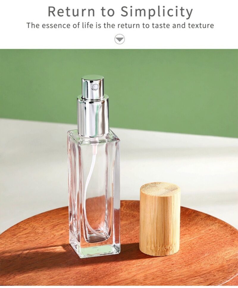 Clear glass perfume bottle with fine mist sprayer and natural bamboo overcap